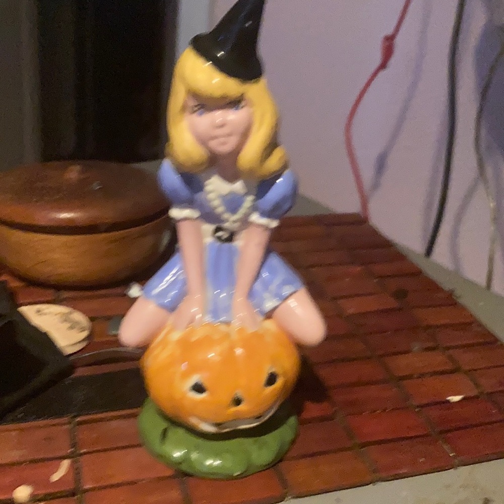Girl ridding pumpkin stem. This is an extremely rare old piece.
